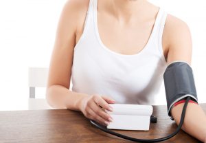 woman checking her blood pressure